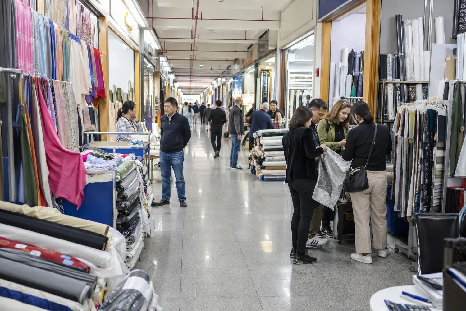 Fabric shops and browsing customers in a Keqiao-style textile market